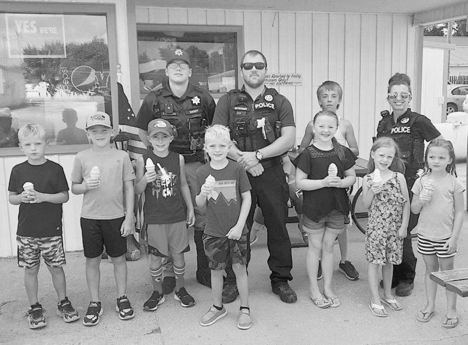 Cherry County Deputy Trevor Willcuts, VPD Officer Ryan McSweeney, VPD Officer Jasmine Hoefs enjoy Cone with a Cop at Frosty Drive In.