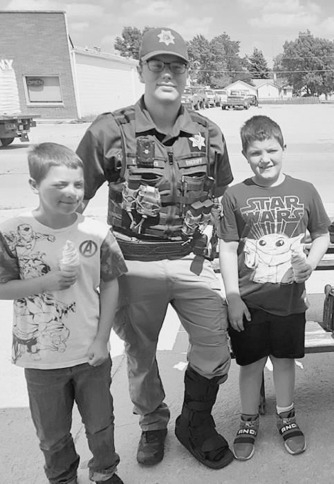 Cherry County Deputy Trevor Willcuts and Valentine Police Officer Jasmine Hoefs with the some of the youth of the community - 57 cones were served Wednesday, July 14, 2021.