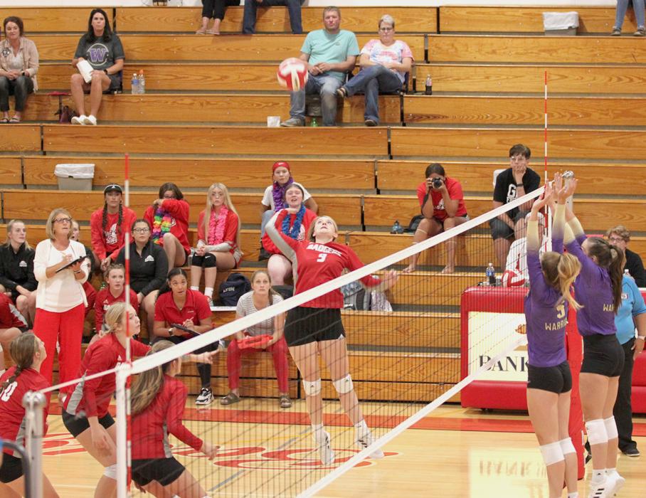 Ashlee Bacon goes up for the return.