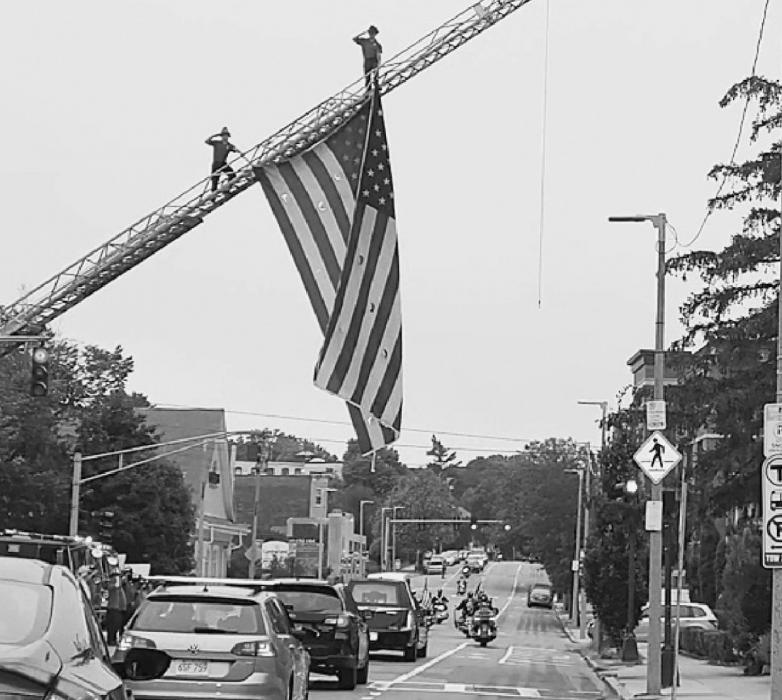 Procession through Brighton, NE and salute from firefighters.