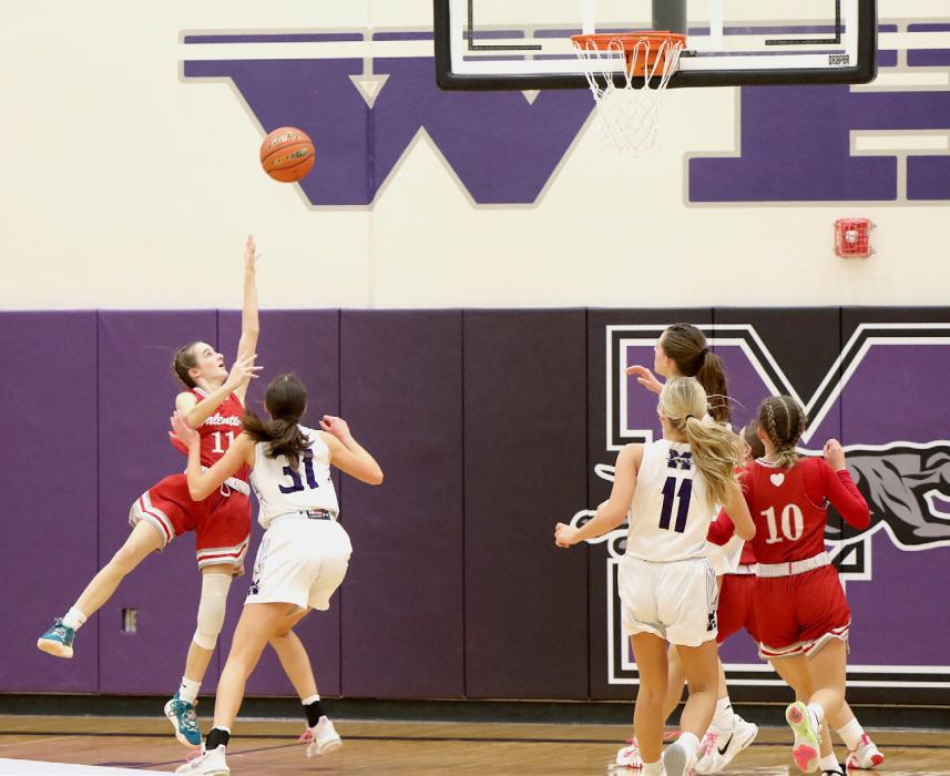 Paige Sprenger makes a go at a basket against the Whippets. Photos by Phil Serrone, Minden Courier
