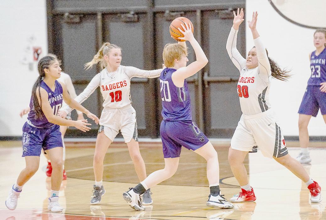 Malika Monroe #30 guards the Minden player, while Kaetryn Bancroft #10 assists. Photos by Fletcher Larsen