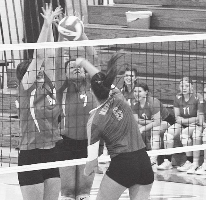 Lainey Egelhoff and Malika Monroe with a block against the Mustangs. Photos by Mary Reagle