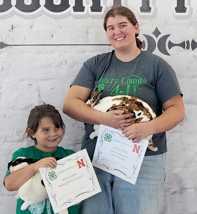 Jenalee Garwood is helped by Jenessa Garwood with the Champion Breeding Rabbit. Jenalee was Champion Senior Rabbit Showman.