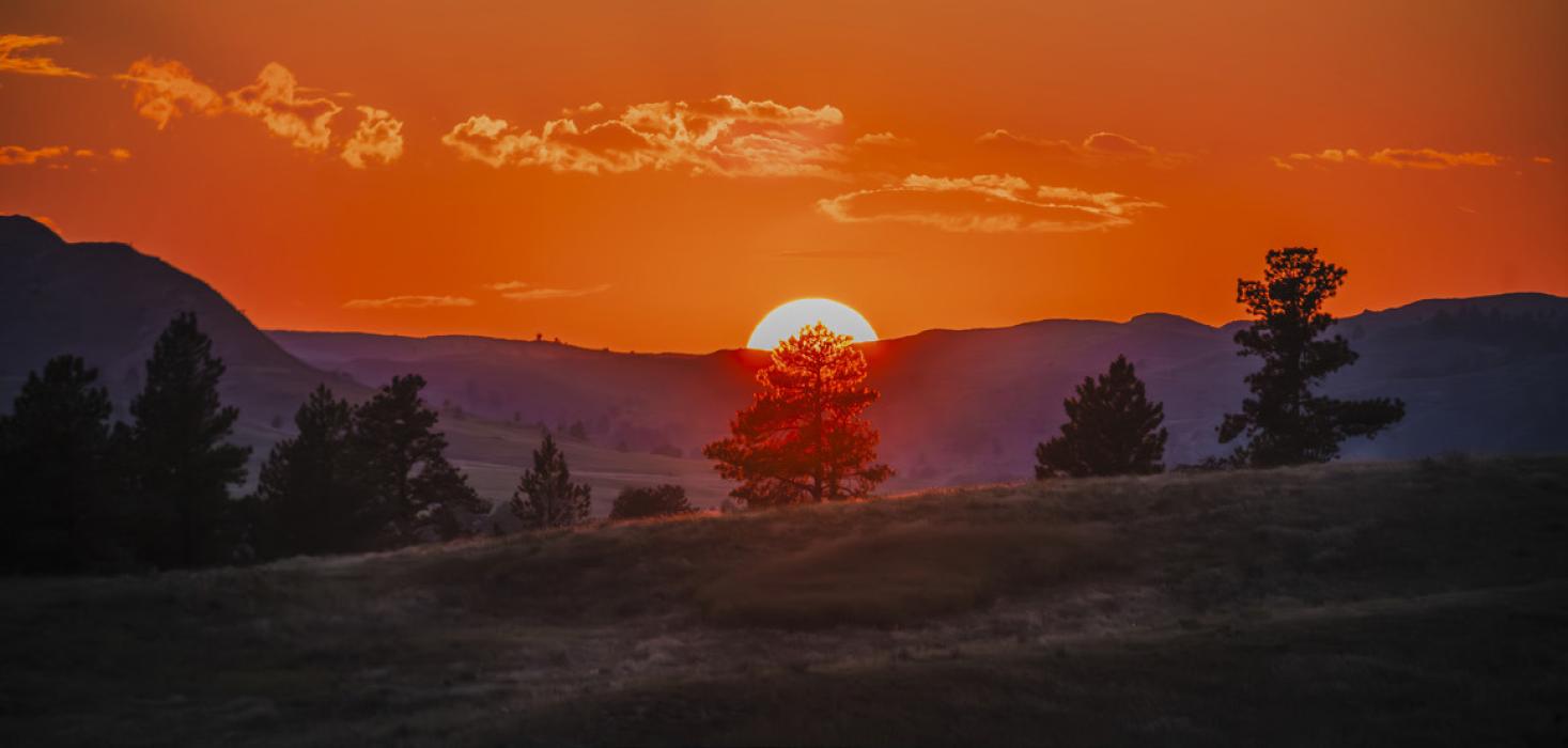 A blazing orange sky from a year ago at Fort Robinson, will now have a different landscape after the South Fork Fire. Photo by Laura Vroman