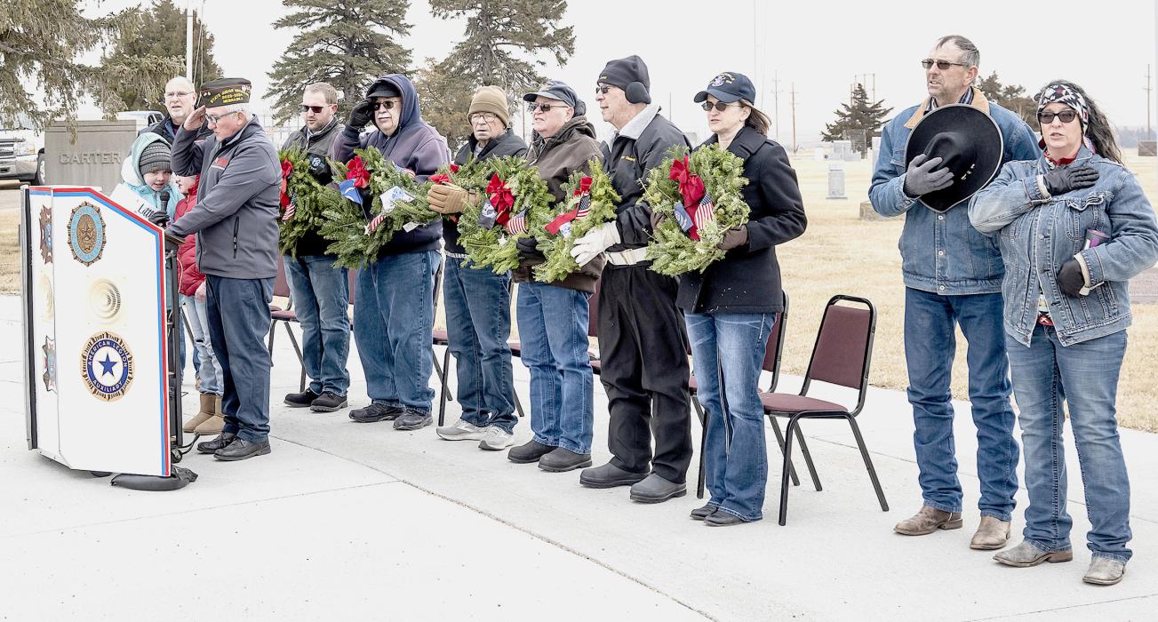 Pictured are from L to R: Pastor Tim Wilkinson, Little Miss Poppy Darby Murphy, Little Miss Poppy-in-Waiting Maggie Arnold, Rex Gallino, Michael Gallino, Bill Potter, Dick Allard, Ron Brown, Sam Spain, Kelly Keough, Rick VanderWey and Kitty VanderWey, who are reciting the Pledge of Allegiance. Photo by Laura Vroman