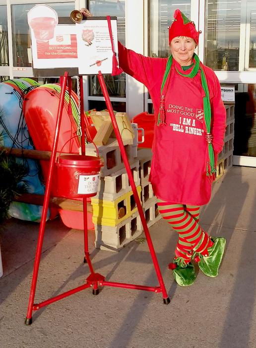 Pat Battershaw dressed in her elfin best to ring the Salvation Army Bell in front of Bomgaars. Check out her velvet shoes!