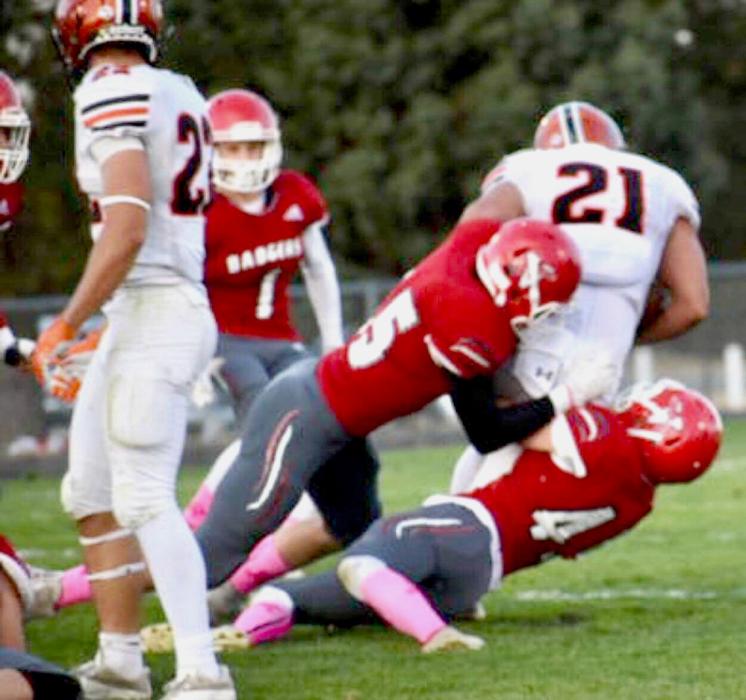 Logan Harp #45 and Cole Simon #55 for the take down in the game against Mitchell.