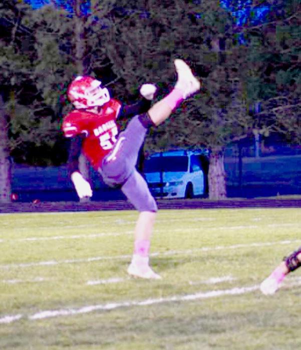 Cole Simon #55 punts the ball in the game against Mitchell. Photos by DeanNa Fowler