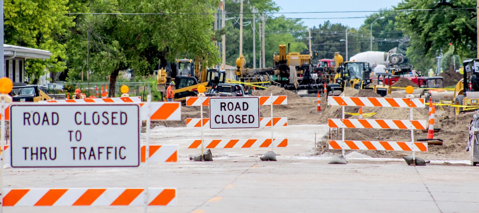 Nine inch doweled concrete roadway is being placed, driveways, and sidewalks are being built. Finish grading is under way.