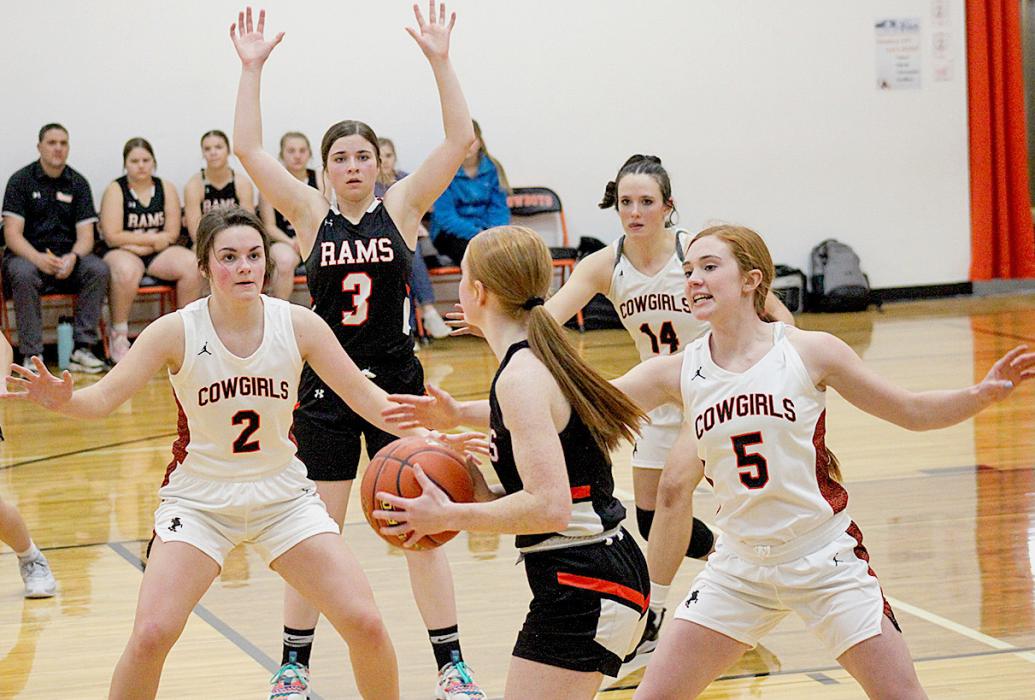Above, the Cowgirls are trying to gain access to the ball! Bottom left, Trey Hand #23 keeps the ball moving against the Warriors Photos by Shontell Roseberry