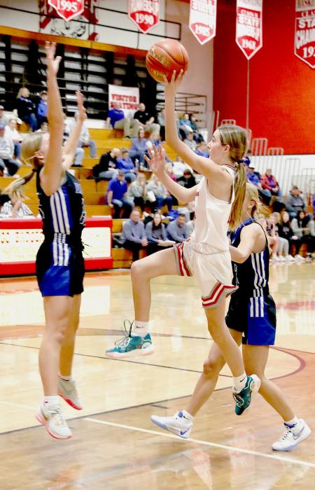 Paige Sprenger #11 going to the hoop in the game against O’Neill. Photos by Nina-Maria Nelson